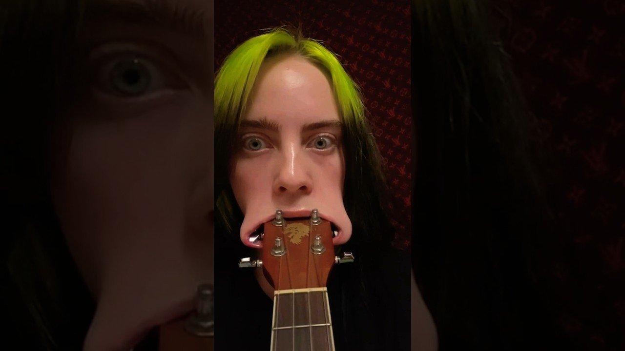 Billie Eilish fits entire ukulele head in her mouth … TWICE 😂 #shorts #billieeilish post thumbnail image